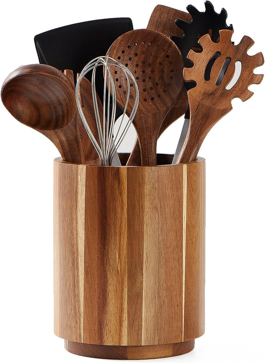 Acacia wood utensil holder on a kitchen worktop filled with tools